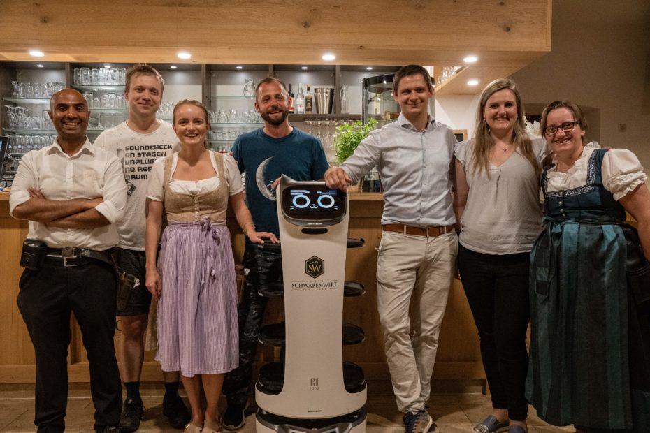 Happy employees with the BellaBot service robot
